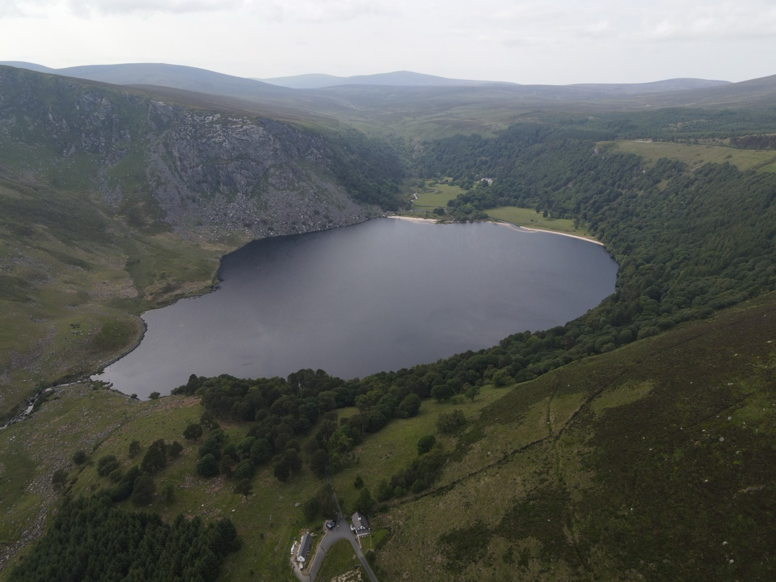Lough Tay's dark waters and pale shore