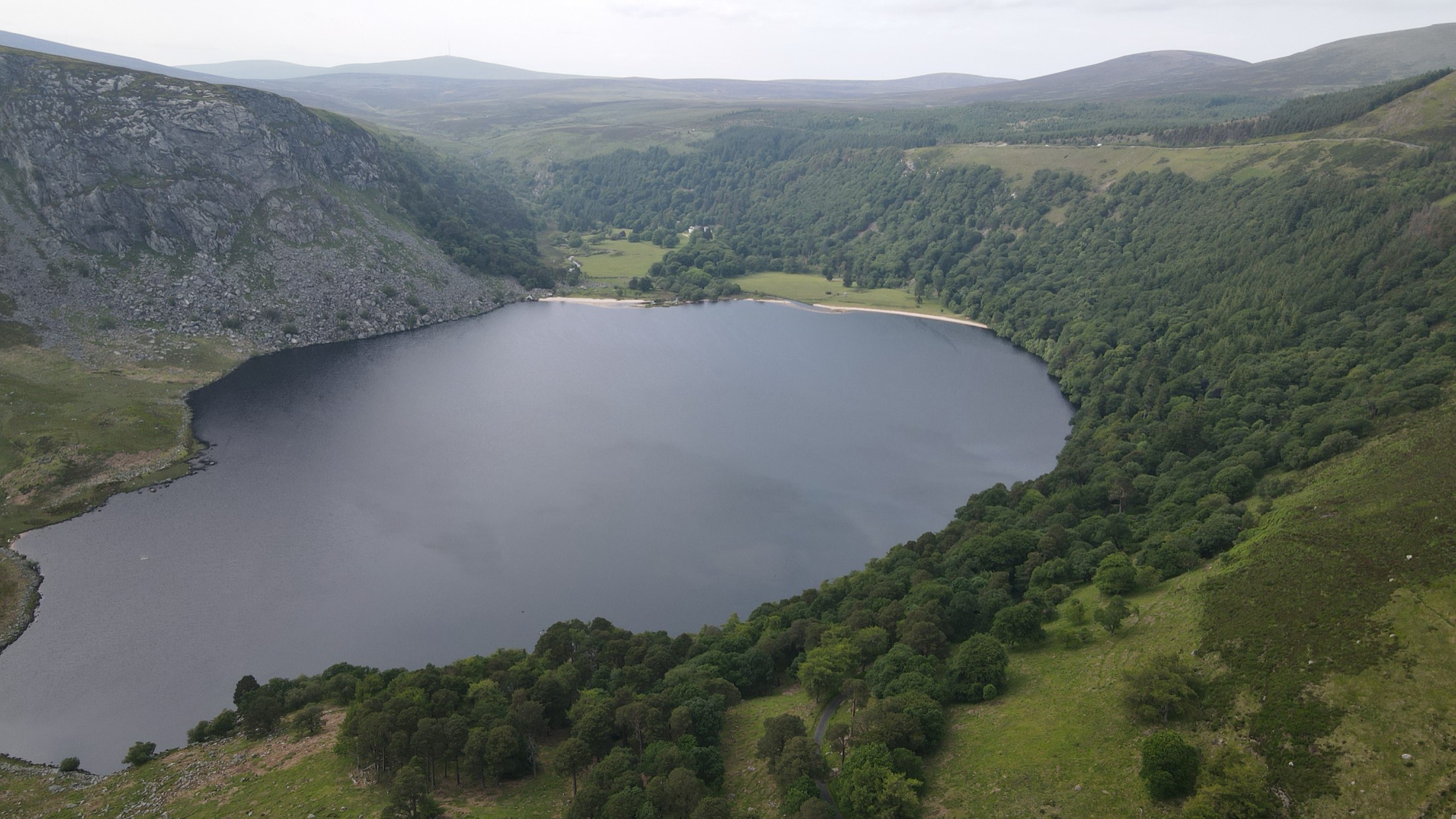 Lough Tay (Guinness Lake) aerial drone view in the Wicklow Mountains — the lake shaped like a pint of Guinness, Ireland