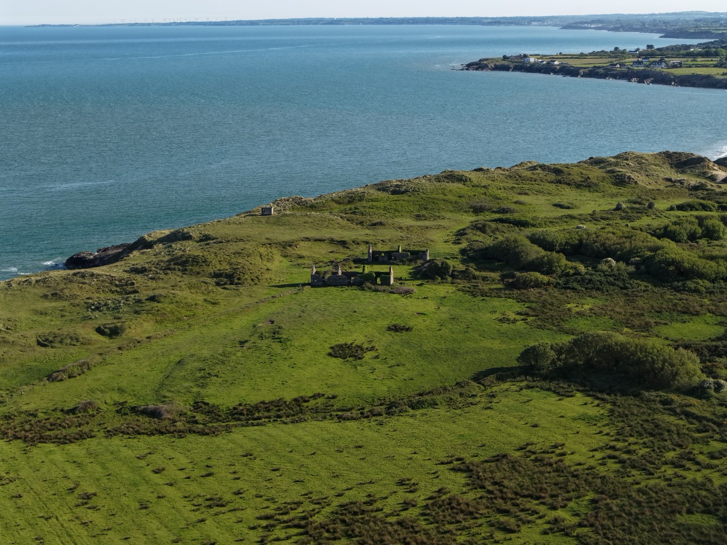 Green headland meeting the Irish Sea at Kilmichael Point