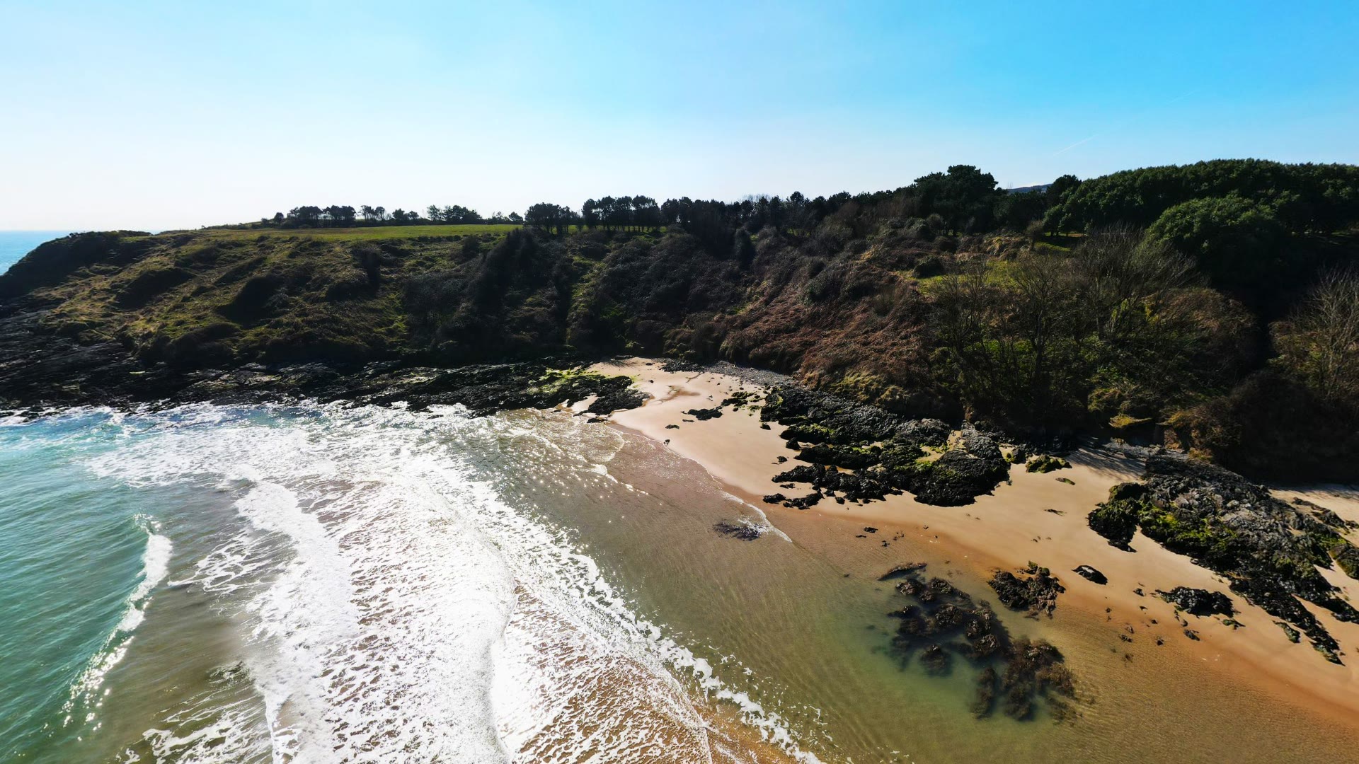 Turquoise surf and rocks at Magheramore cove